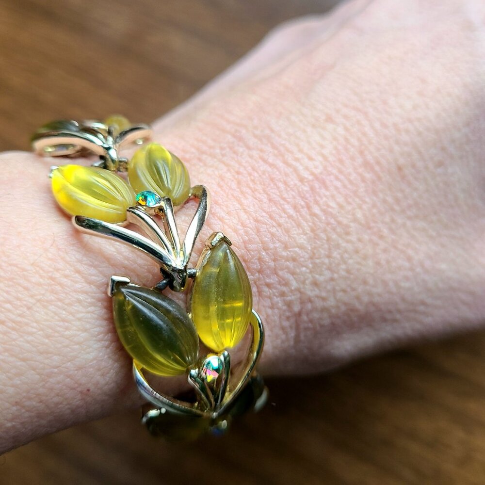 Silver metal thermoset bracelet with yellow leaf shape Aurora Borealis details.